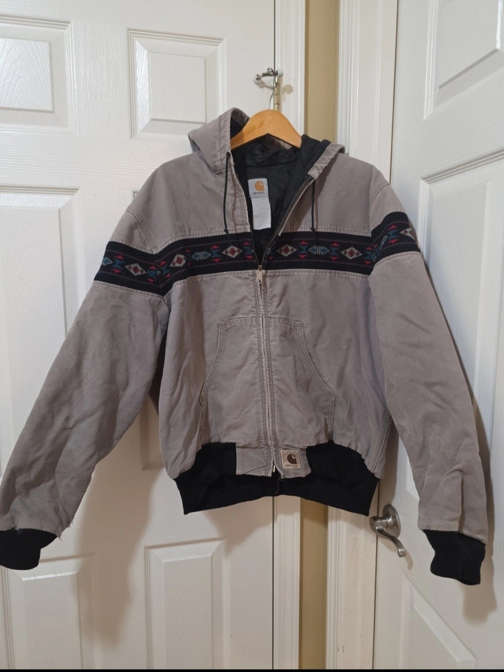 The Vintage 90s Carhartt J78 CMT Aztec Active Hooded Jacket fits like an XL is a